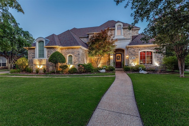 french provincial home with a yard