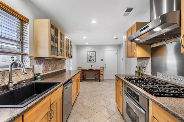 kitchen with sink, decorative backsplash, appliances with stainless steel finishes, and extractor fan