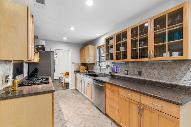 kitchen featuring light tile patterned floors, sink, appliances with stainless steel finishes, and tasteful backsplash