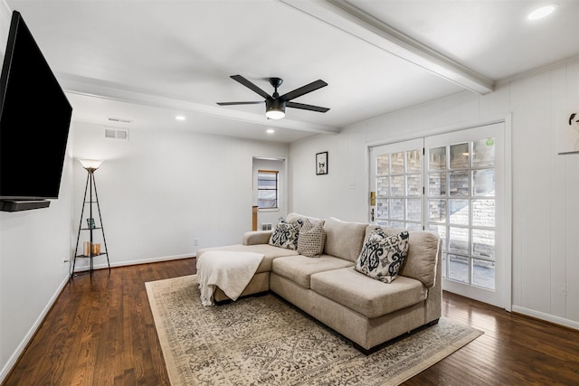 living room featuring ceiling fan, beamed ceiling, and dark hardwood / wood-style flooring