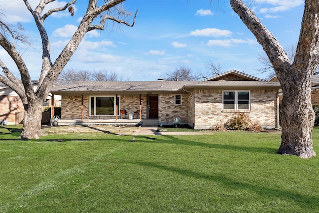 view of front facade with a front lawn and a patio