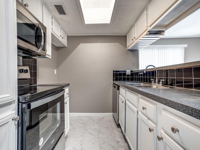 kitchen featuring stainless steel appliances, backsplash, white cabinets, and sink