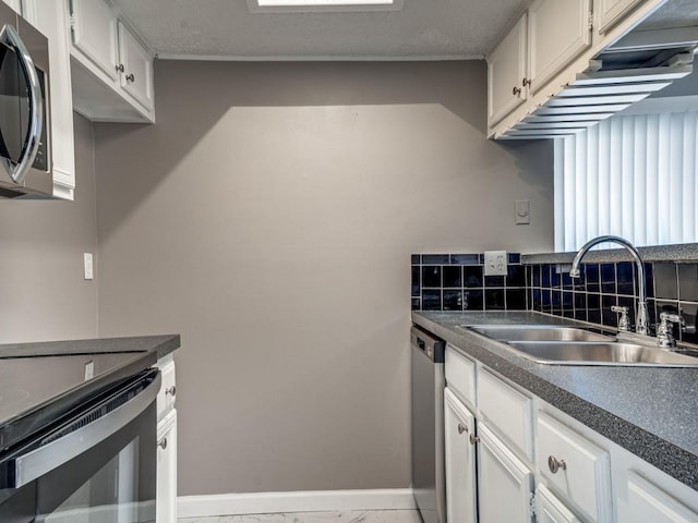 kitchen with white cabinets, sink, and stainless steel appliances