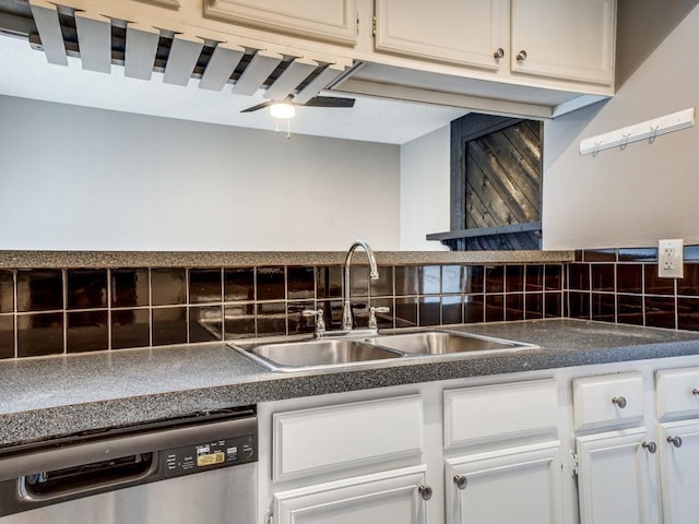 kitchen with ceiling fan, stainless steel dishwasher, decorative backsplash, sink, and white cabinetry