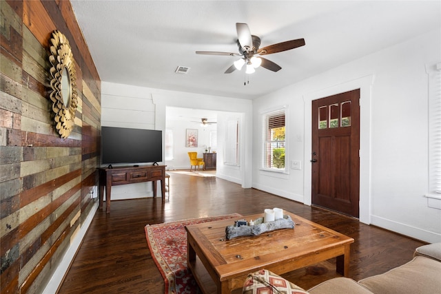 living room featuring ceiling fan and dark hardwood / wood-style flooring