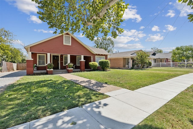 bungalow-style home with a front lawn, a porch, and a garage