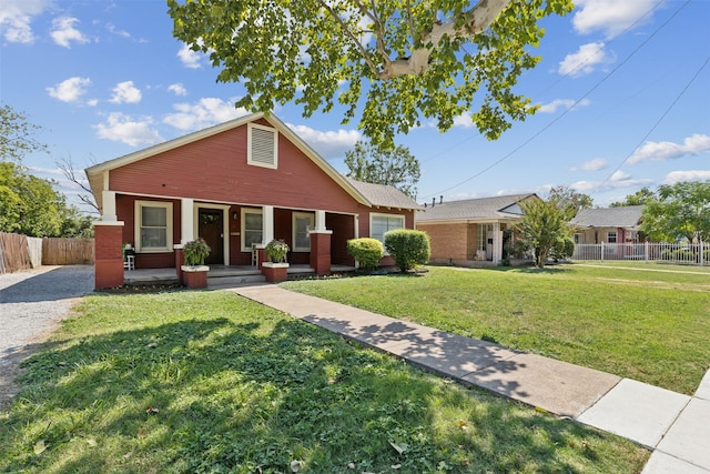 view of front of home with a garage, a front yard, and covered porch