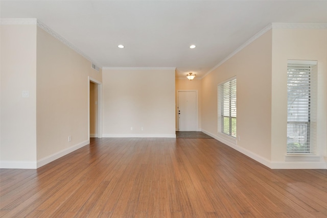 unfurnished room with light wood-type flooring and crown molding