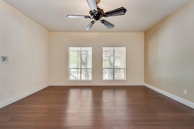 spare room with ceiling fan and dark hardwood / wood-style floors