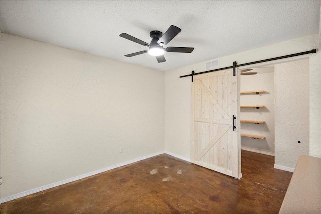 8104 Jolie Dr, Fort Worth, TX 76137 - unfurnished bedroom with concrete floors, a barn door, a textured wall, baseboards, and a textured ceiling