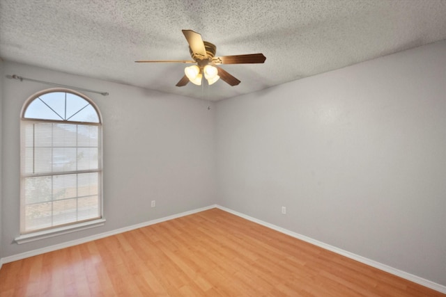 8104 Jolie Dr, Fort Worth, TX 76137 - unfurnished room with light wood-style floors, a ceiling fan, a textured ceiling, and baseboards