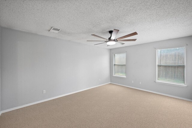 unfurnished room with a textured ceiling, light hardwood / wood-style floors, and ceiling fan