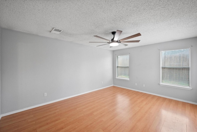 8104 Jolie Dr, Fort Worth, TX 76137 - empty room featuring wood finished floors, a ceiling fan, baseboards, and a textured ceiling