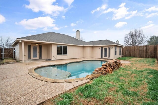 view of pool with a yard, a patio area, and ceiling fan