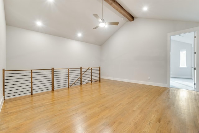 empty room featuring ceiling fan, high vaulted ceiling, beamed ceiling, and light wood-type flooring