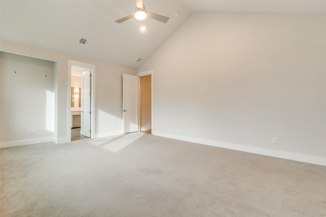 unfurnished bedroom with light carpet, ceiling fan, connected bathroom, and high vaulted ceiling