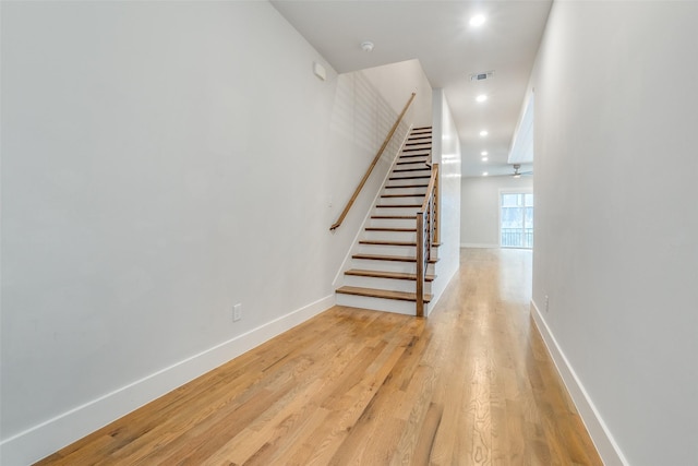 stairs featuring wood-type flooring