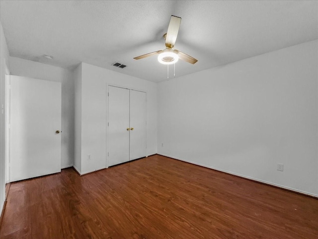 unfurnished bedroom featuring a closet, ceiling fan, and wood-type flooring