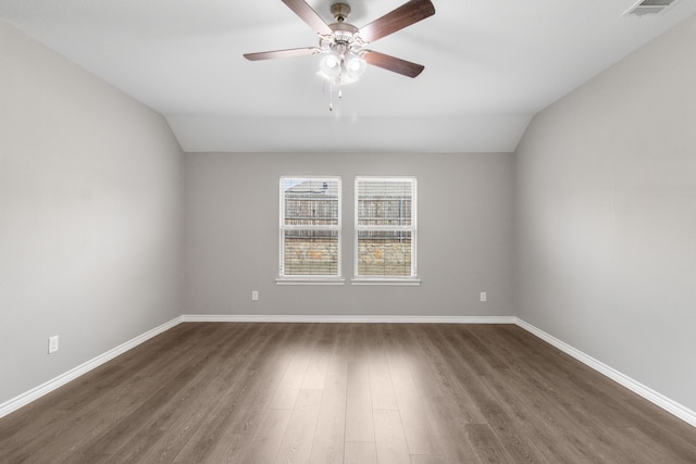 unfurnished room featuring ceiling fan, dark hardwood / wood-style flooring, and vaulted ceiling