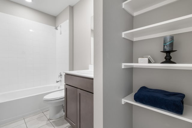 full bathroom with tile patterned floors, toilet, vanity, and tiled shower / bath combo