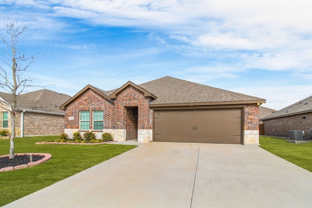 ranch-style home featuring a front yard, a garage, and central AC