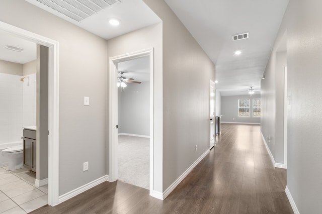 corridor with hardwood / wood-style flooring