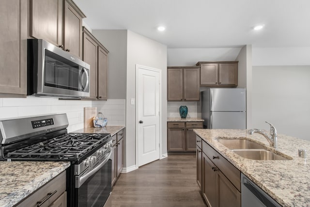 418 Rawhide Way, Princeton, TX 75407 - kitchen with appliances with stainless steel finishes, a sink, dark wood finished floors, light stone countertops, and recessed lighting
