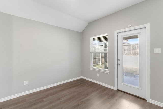 entryway with vaulted ceiling and hardwood / wood-style flooring