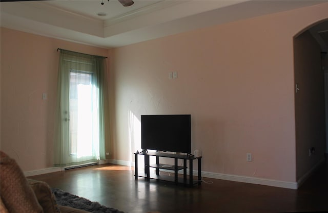 living room featuring a raised ceiling, dark hardwood / wood-style floors, and ceiling fan