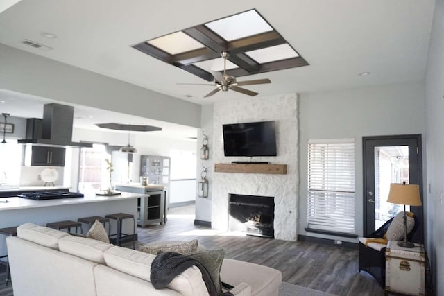 living room featuring ceiling fan, wine cooler, dark hardwood / wood-style floors, and a fireplace