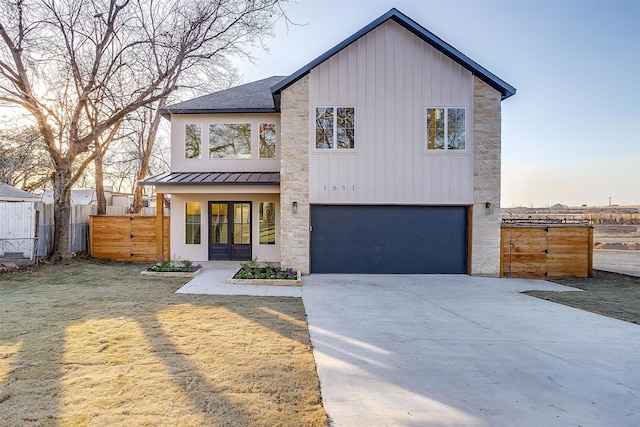 view of front of home with a garage and a yard