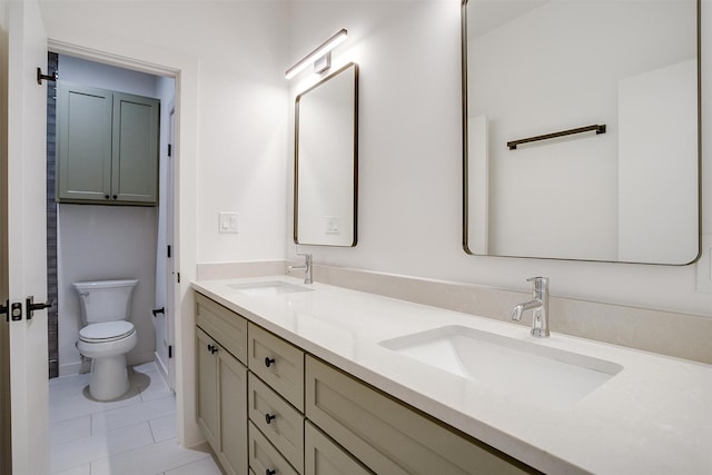 bathroom with vanity, tile patterned floors, and toilet