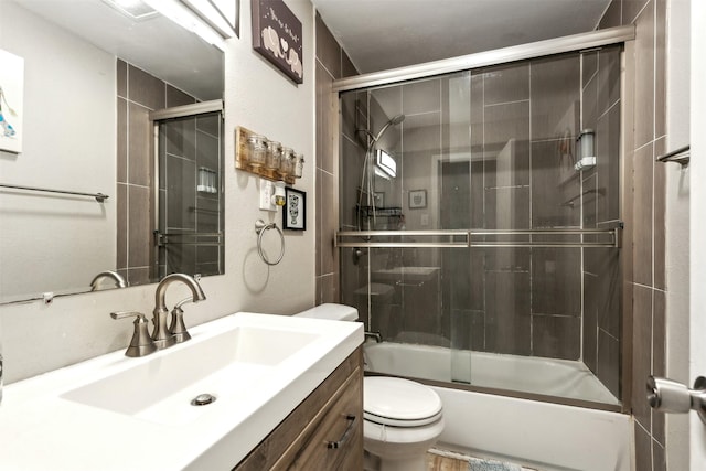 full bathroom featuring toilet, vanity, and combined bath / shower with glass door