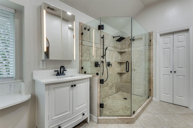 7800 Glenoaks Dr, Frisco, TX 75034 - bathroom featuring tile patterned flooring, lofted ceiling, walk in shower, and vanity
