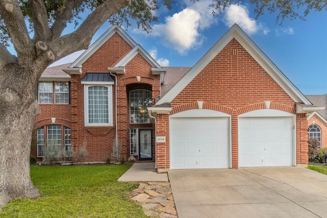 view of front property featuring a garage and a front lawn