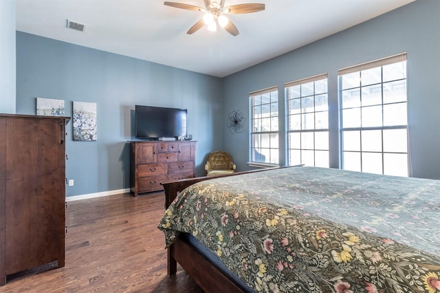 bedroom with ceiling fan and dark hardwood / wood-style flooring