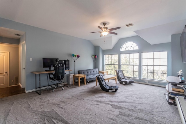 interior space with ceiling fan, vaulted ceiling, and carpet flooring