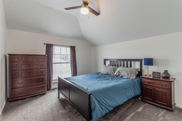 bedroom with ceiling fan, lofted ceiling, and dark colored carpet