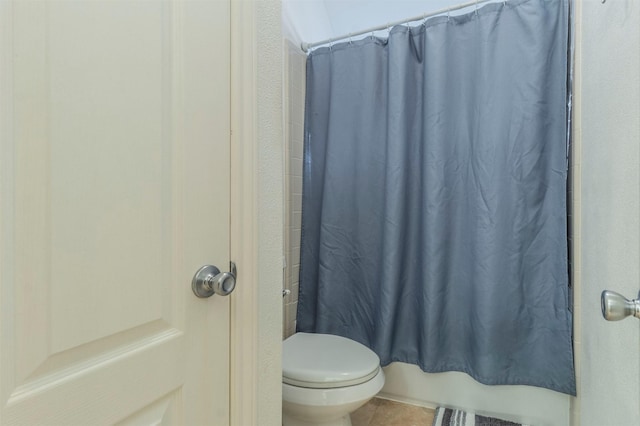 bathroom with toilet and shower / tub combo with curtain