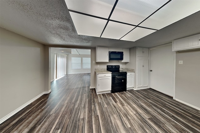 kitchen featuring a textured ceiling, dark wood-type flooring, white cabinets, and black appliances