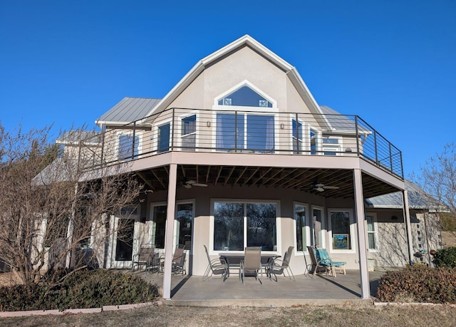 back of house with a balcony, a patio, and ceiling fan