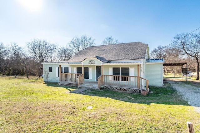 view of front of home with a front yard, a porch, and a carport