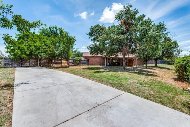 ranch-style house featuring a fenced front yard and a front yard