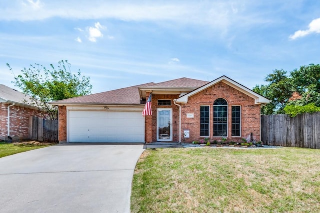 single story home with an attached garage, fence, a front lawn, and brick siding