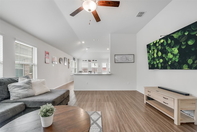 living room with wood-type flooring, sink, lofted ceiling, and ceiling fan