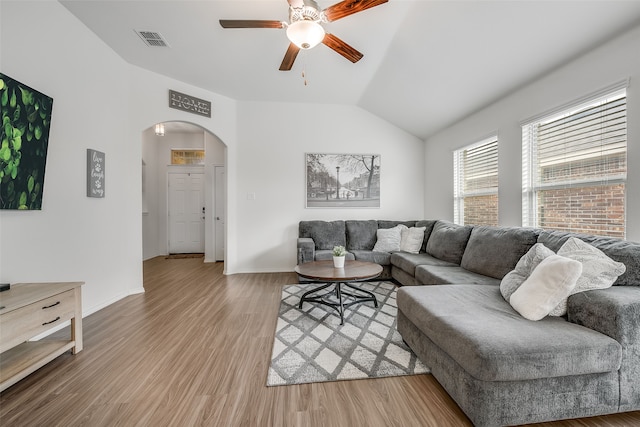 living room with ceiling fan, lofted ceiling, and wood-type flooring