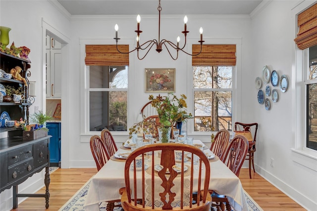 dining space featuring a chandelier, crown molding, and light hardwood / wood-style flooring