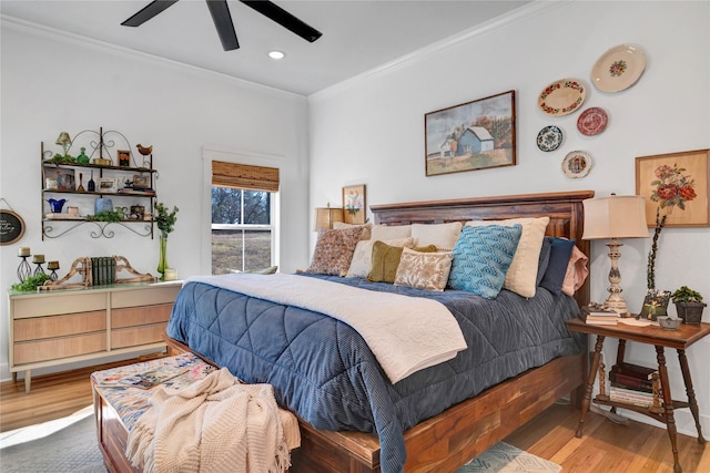 bedroom with ceiling fan, wood-type flooring, and crown molding