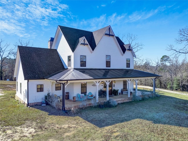 view of front facade with a front lawn and covered porch