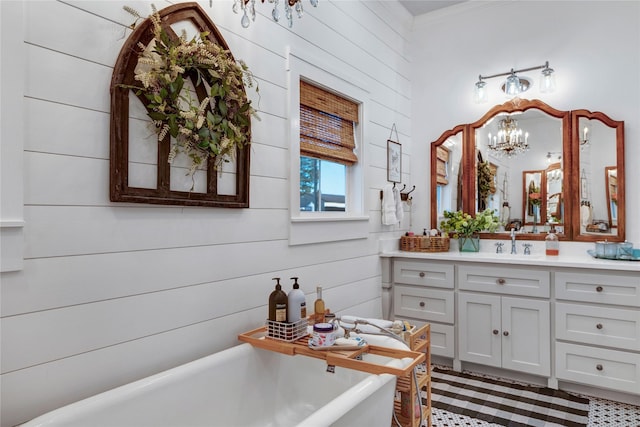 bathroom with a tub to relax in, vanity, wood walls, and a chandelier